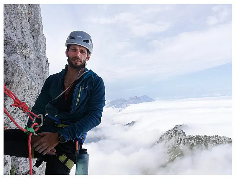 Paul from Run and Rock Guiding harnessed to a mountain rock face